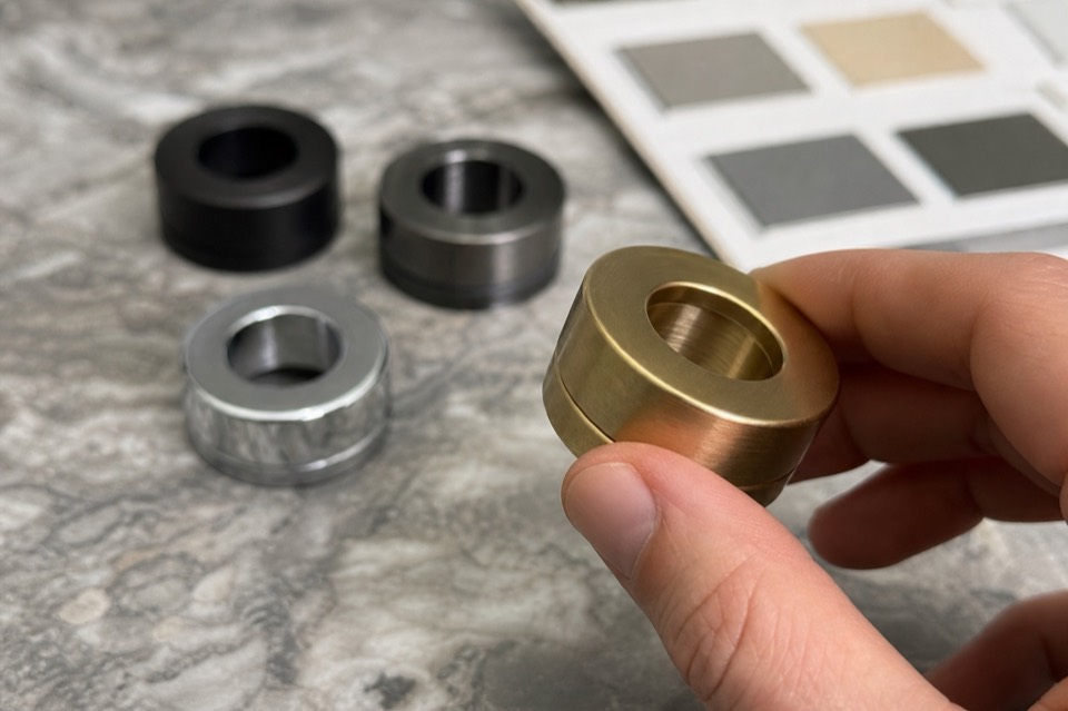 Hand comparing sanitary hardware finish samples